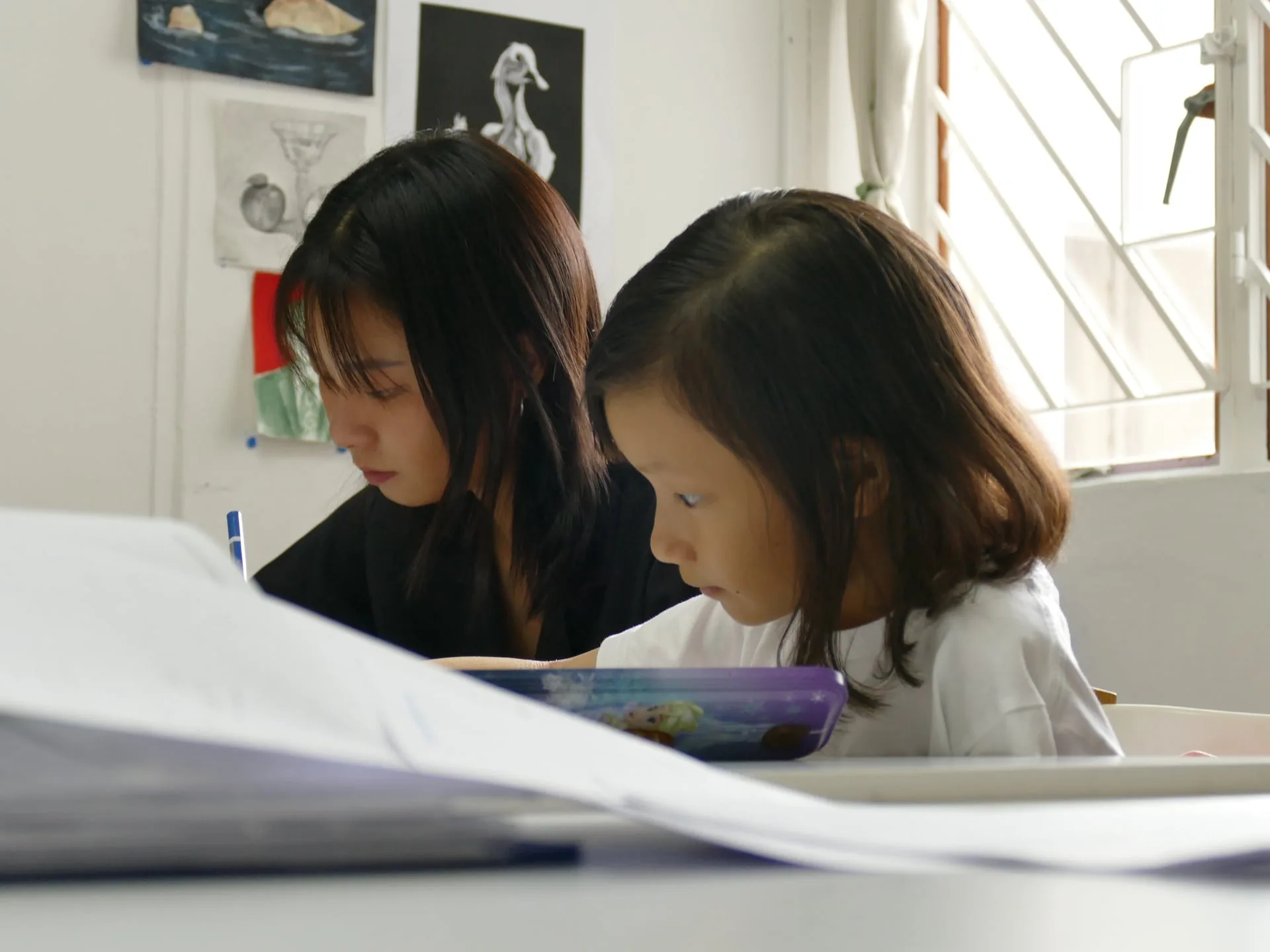 Teacher explaining concepts on whiteboard during trial lesson