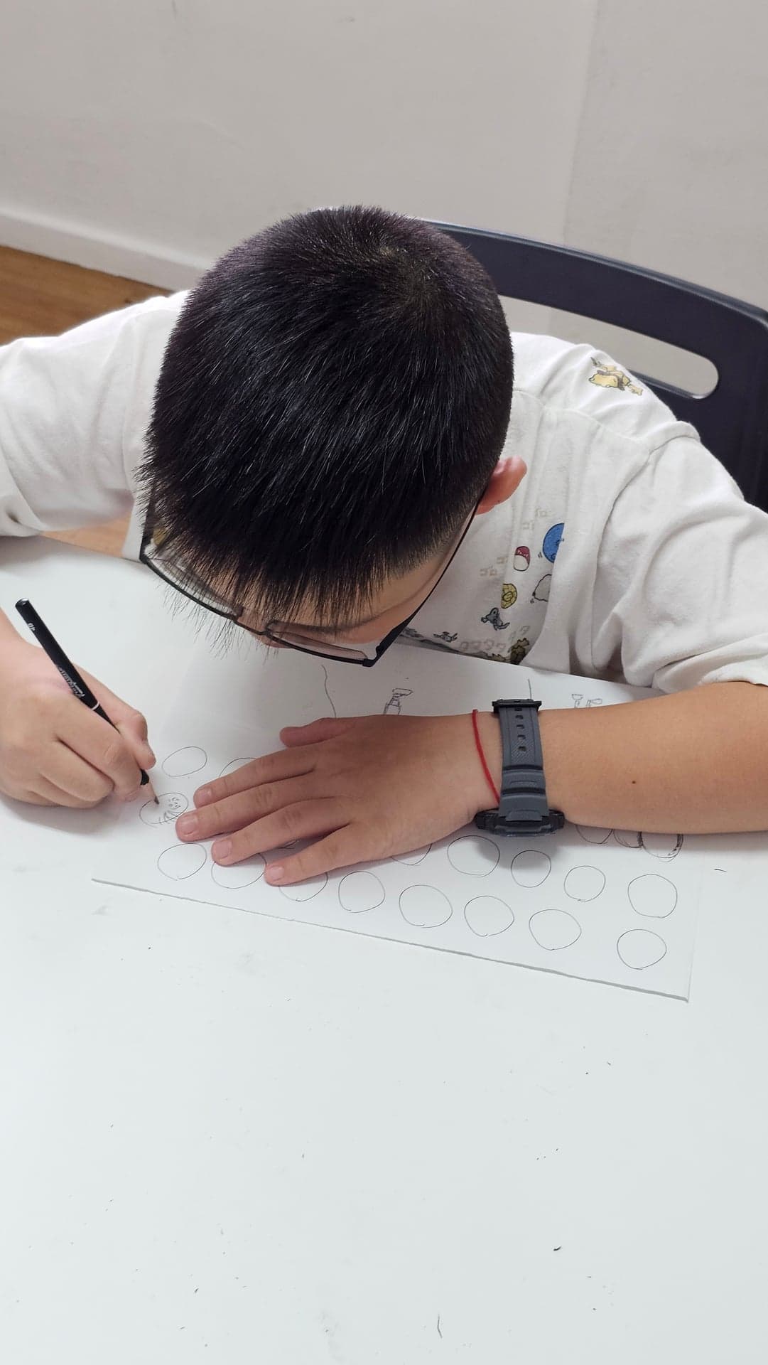 Student practising pencil shading fundamentals with rows of graded spheres at Art by Ancourage