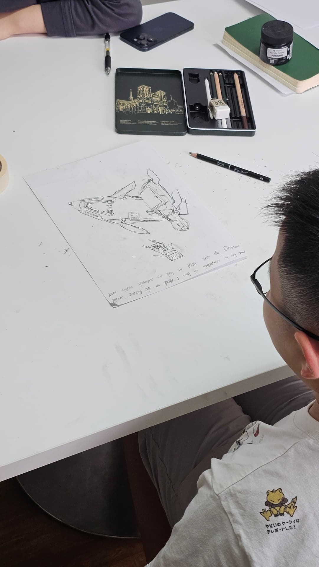 Teenage student drawing a mecha robot in fine-line pencil at an Art by Ancourage manga and anime class