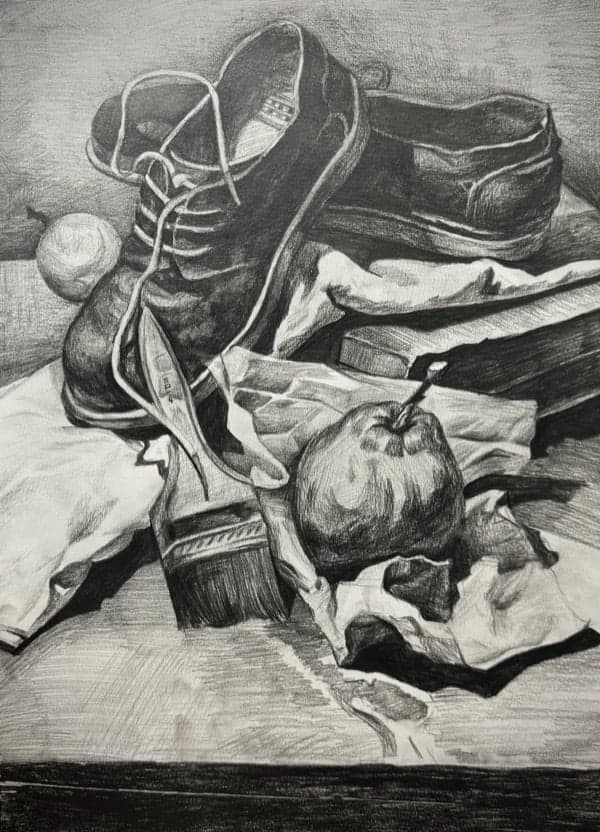 Advanced graphite still-life study of boots, a pear and a paintbrush from an Art by Ancourage class