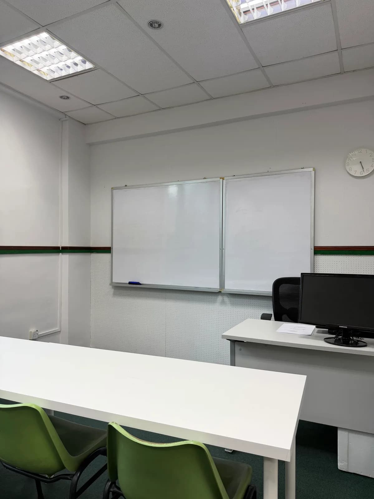 Small-group classroom at Ancourage Academy Woodlands with twin whiteboards and a teaching screen.