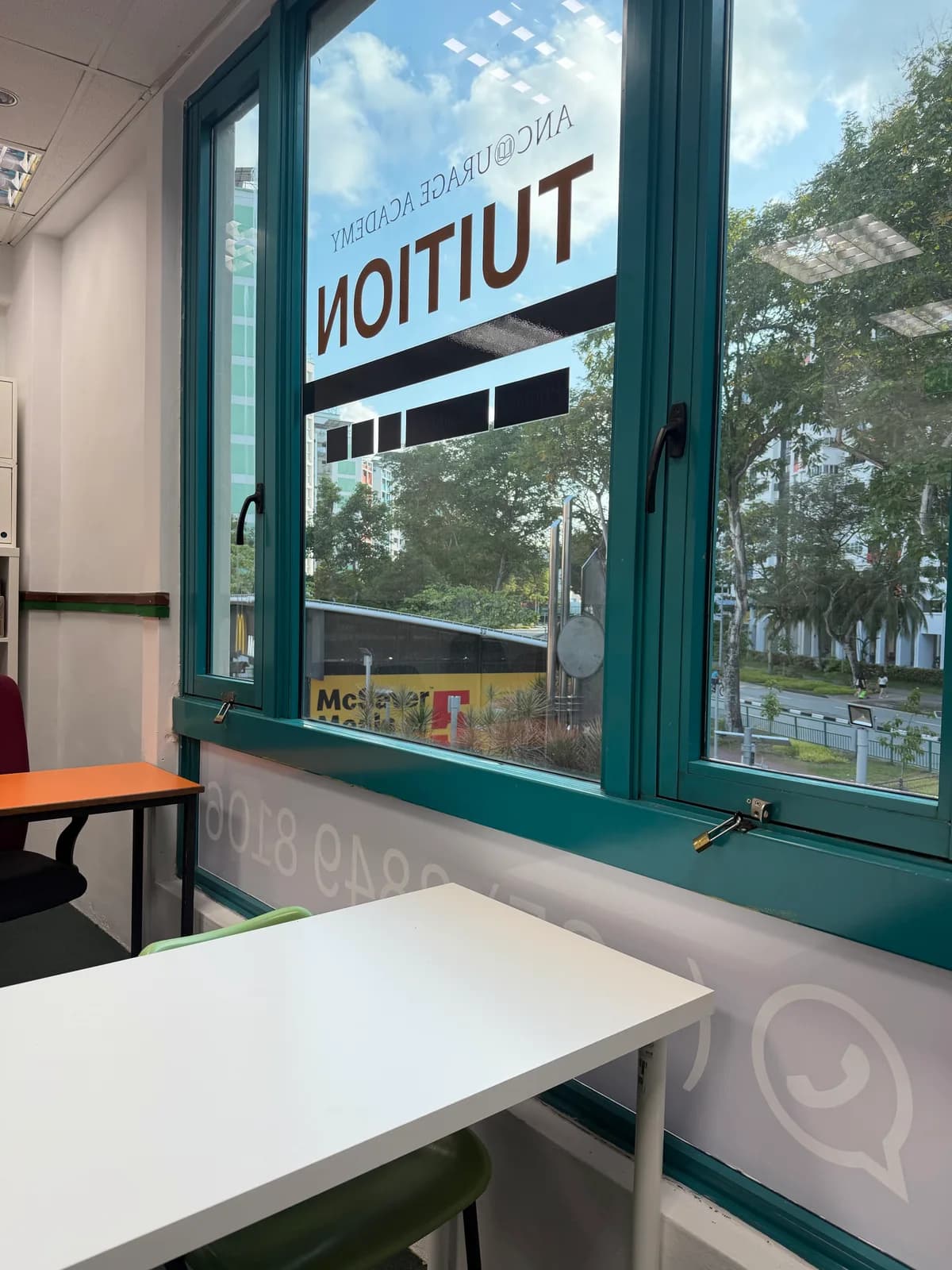 Bright classroom at Ancourage Academy Woodlands with teal-framed windows overlooking the greenery along Woodlands Drive 44.