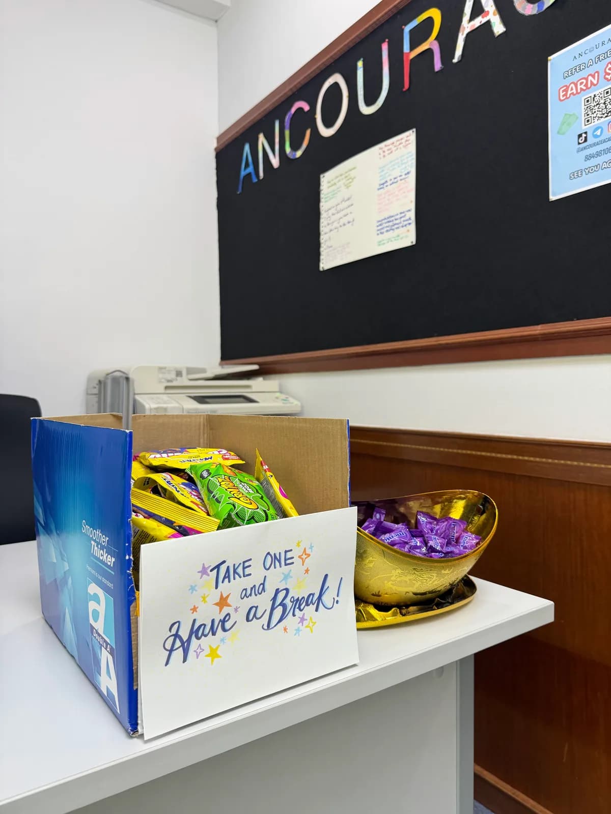 Snack corner at Ancourage Academy Woodlands — a 'Take One and Have a Break' box for students between classes.